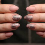 Stylish manicure nails on a beautiful textural background