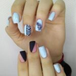 beautiful blue manicure of nails on the background of fashionable texture