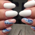 Closeup photo of a beautiful female hands with elegant manicure and diamond rings.