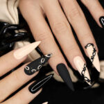 Beige and black manicure on long nails.