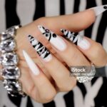 Gel manicure on the sharp shape of nails with an animalistic print.