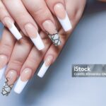 Acrylic nail extension. Manicure. Nail correction. Hands in the foreground. copy space.